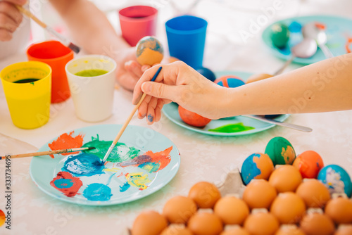 Family Easter Decoration Painting Eggs Mom with three kids