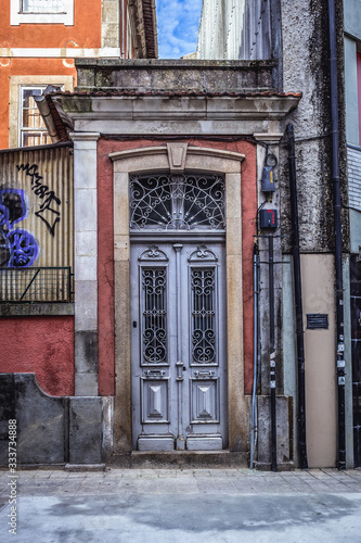 Decorated metal door of a townhouse courtyard in Cedofeita district of Porto, Portugal
