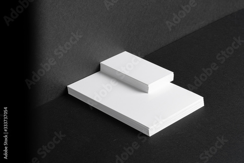 Stacked white businesscards for branding identity on black background, copy space photo