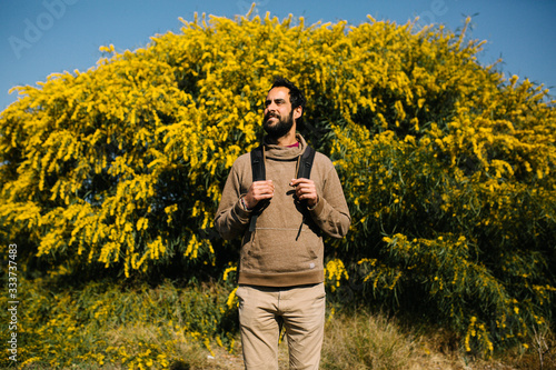 bearded man with backpack by the yellow tree © Miguel Valls