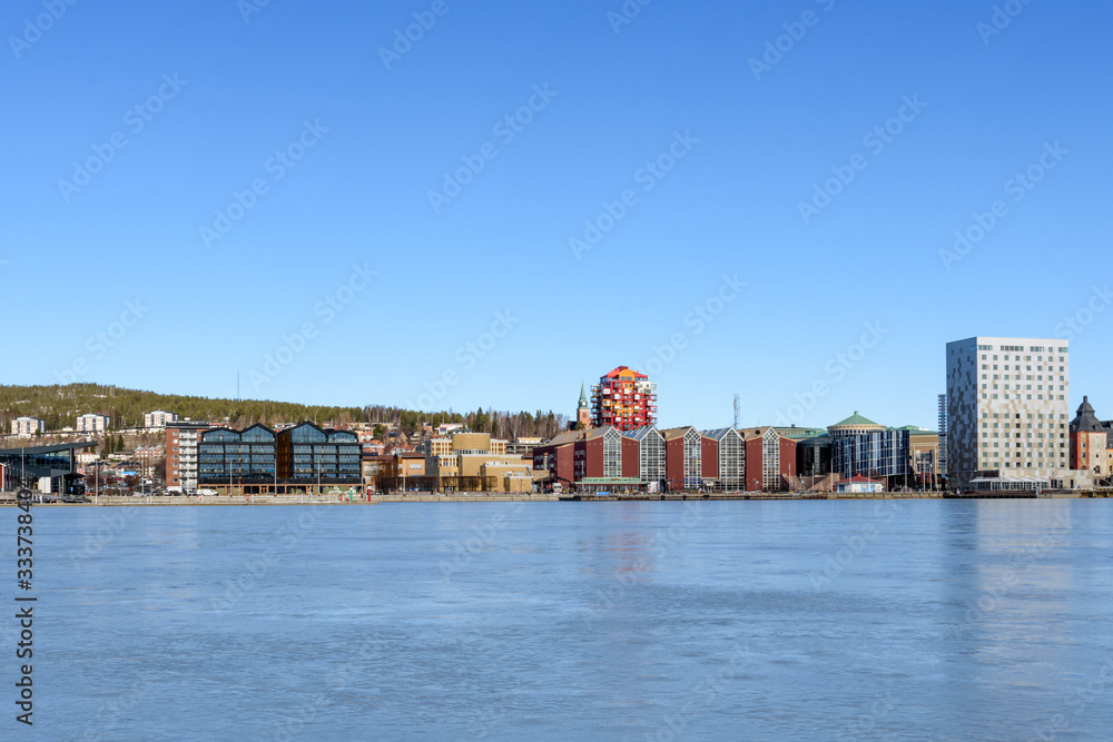 Northern part of Ornskoldsvik town from sea side with a blue sky in background