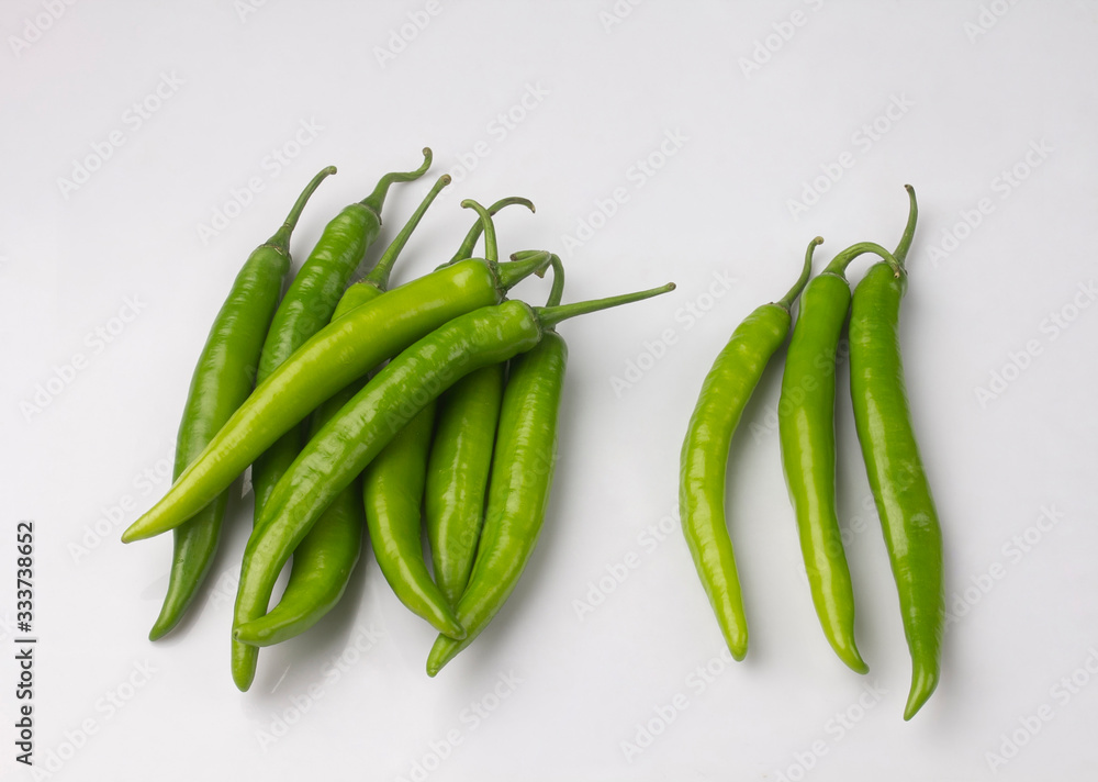 Bunch of green chili peppers isolated on white Bunch of green chili peppers isolated on white