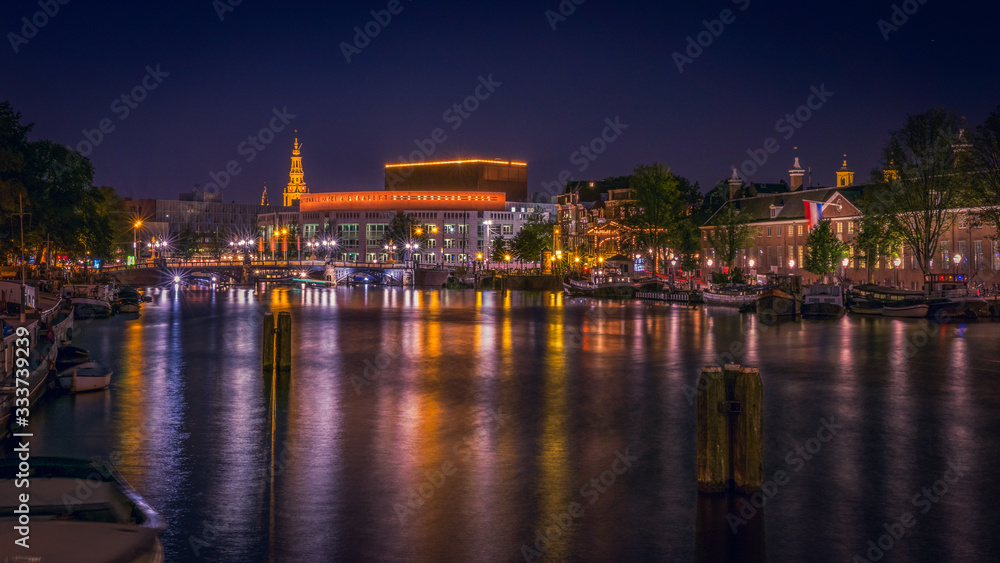 Amstel Canal at night with view of the National Opera & Ballet H