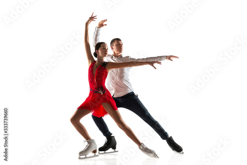 Duo figure skating isolated on white studio backgound with copyspace. Two sportsmen practicing and training in action and motion. Full of grace and weightless. Concept of movement, sport, beauty.
