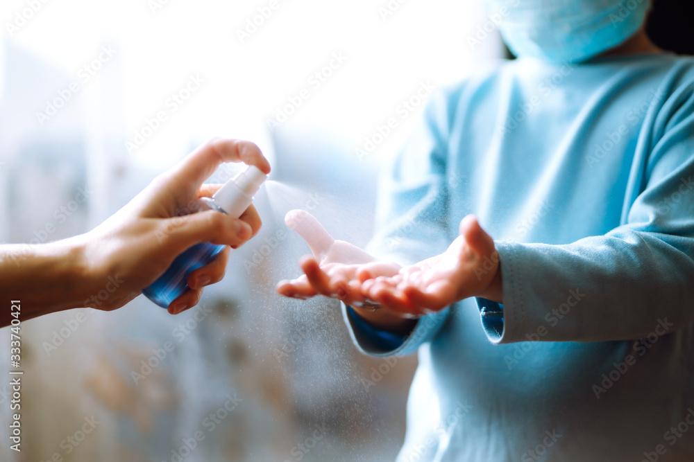 Avoiding Infection Hands with sanitizer antiseptic. Mother and child using sanitize ...