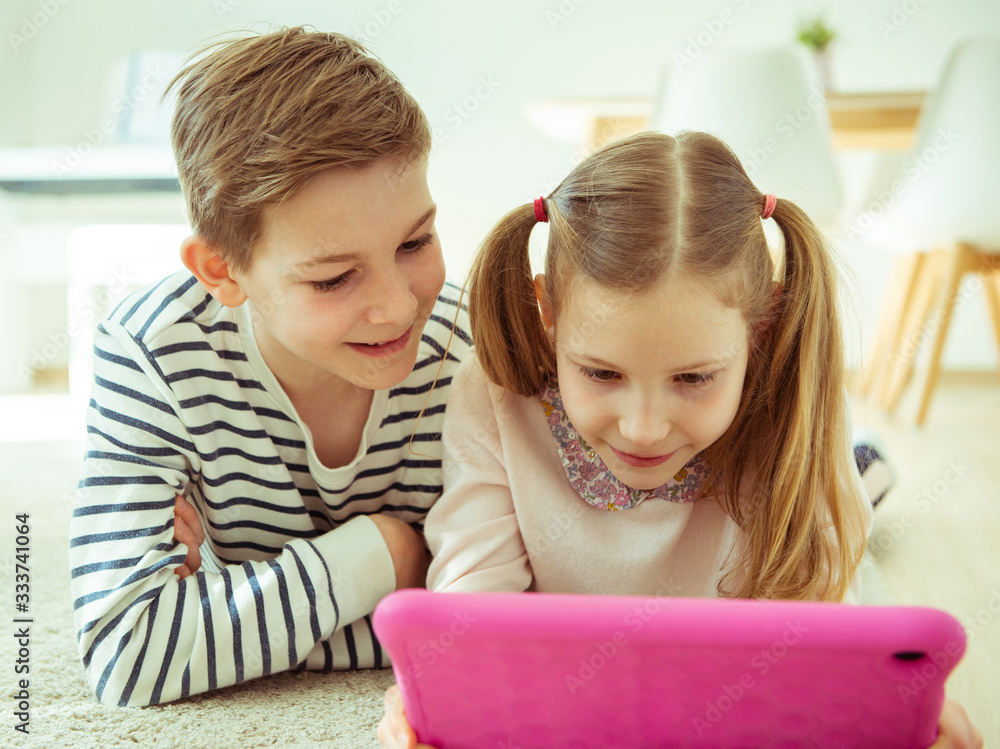 Happy children speaking and with friends using laptop during quaranrine Happy children speaking and with friends using laptop during quaranrine
