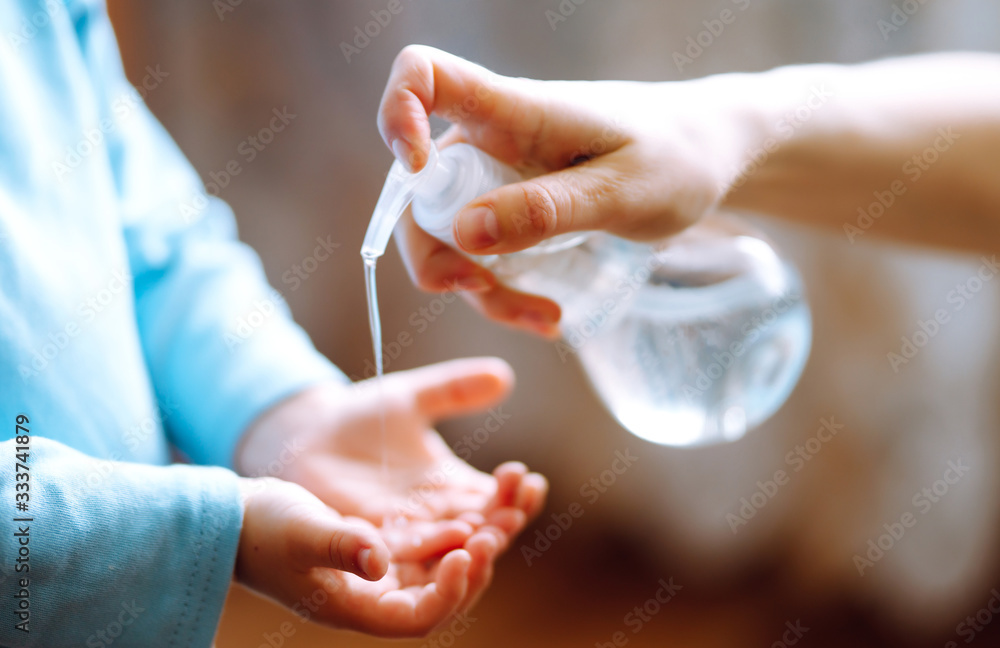 Hands with sanitizer gel. Mother and child using sanitize soap for hand coronavirus protection. Hygiene concept. Virus and illness protection, hand sanitizer in quarantine city. Hands with sanitizer gel. Mother and child using sanitize soap for hand coronavirus protection. Hygiene concept. Virus and illness protection, hand sanitizer in quarantine city.