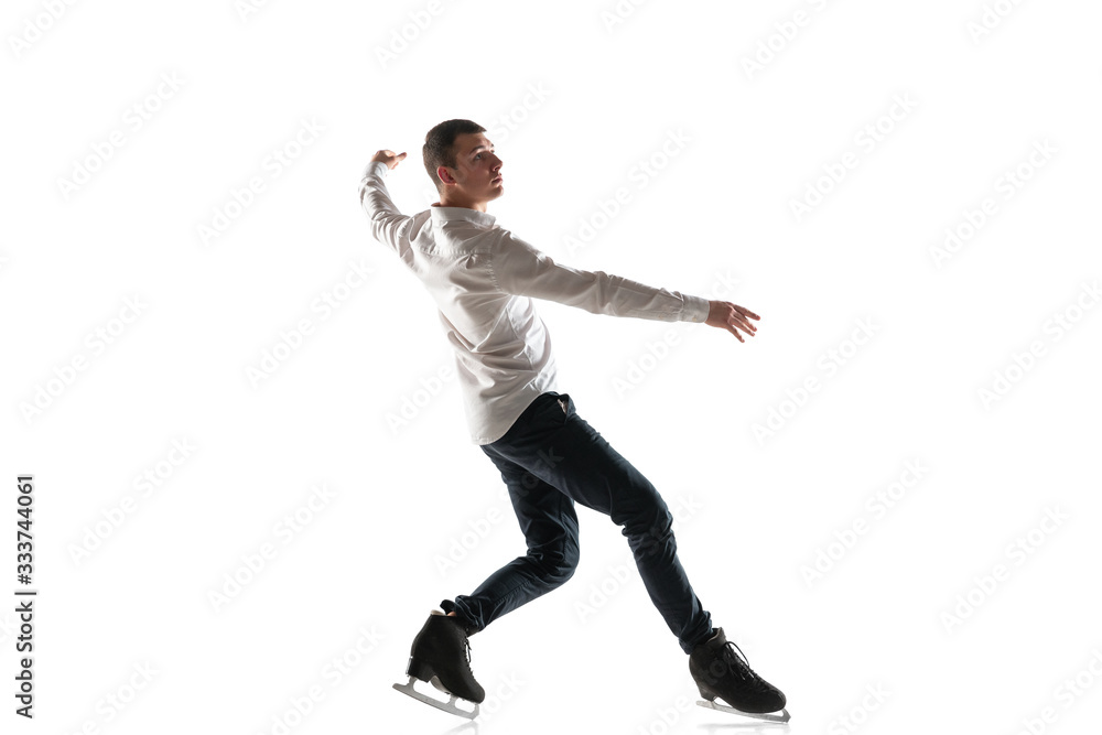 Man figure skating isolated on white studio backgound with copyspace. Professional practicing and training in action and motion on ice. Graceful and weightless. Concept of movement, sport, beauty. Man figure skating isolated on white studio backgound with copyspace. Professional practicing and training in action and motion on ice. Graceful and weightless. Concept of movement, sport, beauty.