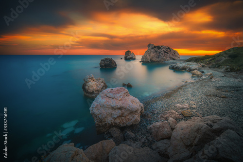 Beautiful sunset at Petra tou Romiou - Aphrodite's Rock, the birthplace of Aphrodite and a popular tourist location between Limassol and Paphos in Cyprus.