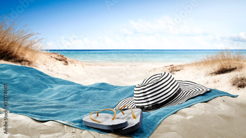 Fototapeta Naklejka Na Ścianę i Meble -  blue towel with hat and summer beach 
