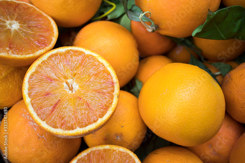 Oranges on the counter of farmers market. Half cut orange