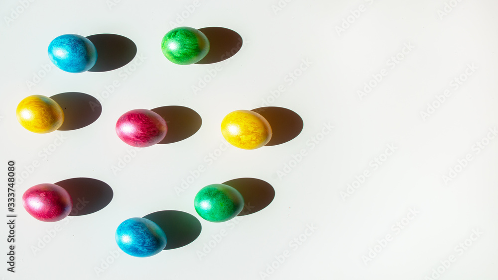 Colorful easter eggs on white background. Happy Easter composition. Copy space.