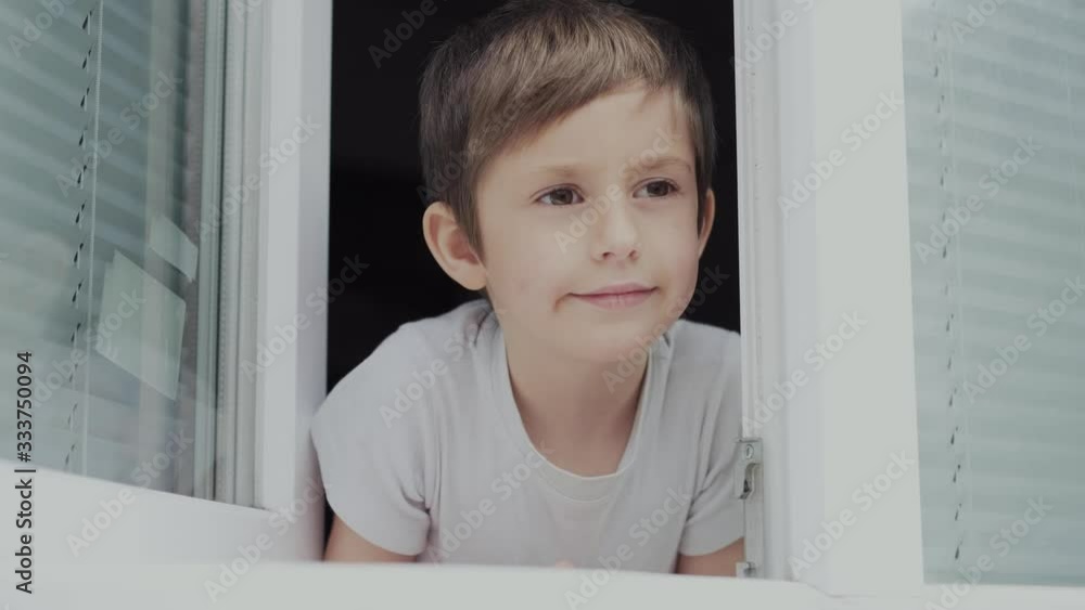 A boy of five years old is bored, because of quarantine he is deprived of a walk in the yard. Quarantine restriction measures for the population. A boy of five years old is bored, because of quarantine he is deprived of a walk in the yard. Quarantine restriction measures for the population.