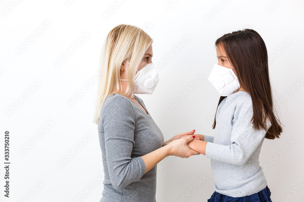 young mother wearing protective PM2.5 mask for her Daughter. isolated on white background. young mother wearing protective PM2.5 mask for her Daughter. isolated on white background.