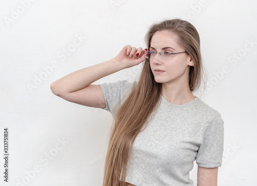 Sexy girl with long hair in glasses looking. Education, optics,