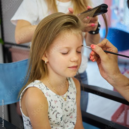 Children make up. Glitter makeup. Sparkles on cheek.