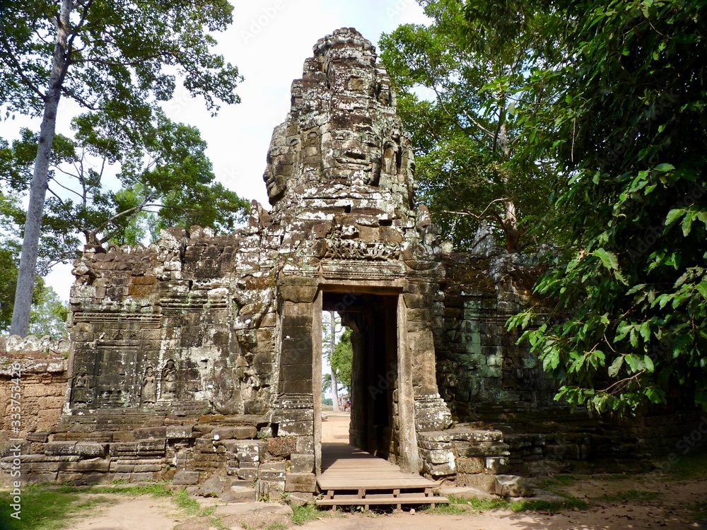 Ruins of Angkor, temple of Preah Khan, stone gate with face tower before trees, Angkor Wat, Cambodia