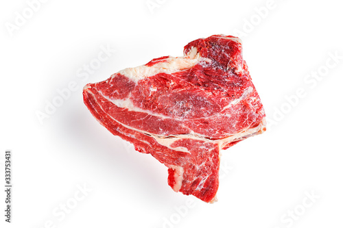 A frozen piece of beef meat on an isolated white background.