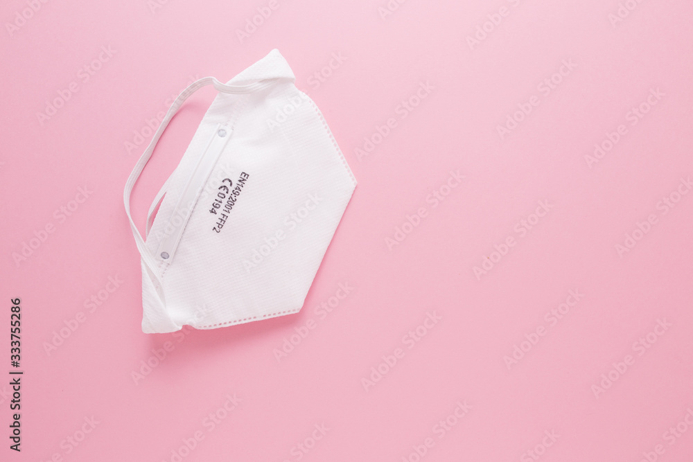 White medical mask on a pink background. Virus protection. Covid19 White medical mask on a pink background. Virus protection. Covid19