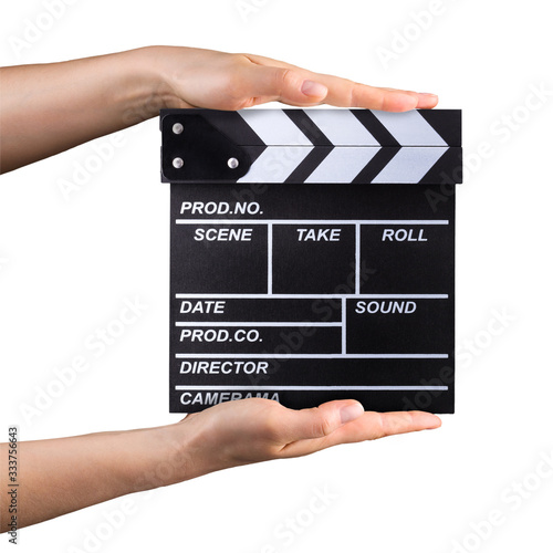 Human hand holding film clapper board isolated on white background with clipping path photo