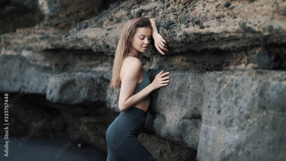 Portrait of sensual young woman looks at camera and moves her hands smoothly Portrait of sensual young woman looks at camera and moves her hands smoothly