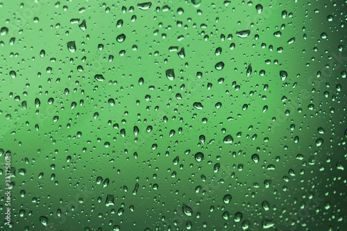 Water Drops./ Water drops on glass. Drops of water on a color background. Green/Gray. Toned.