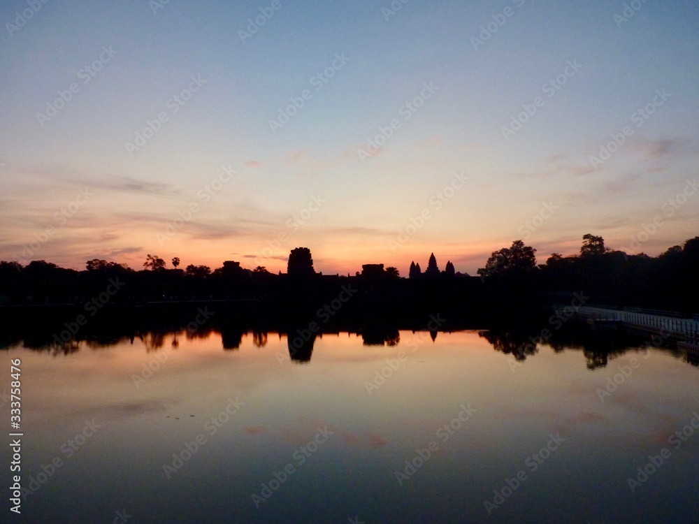 Angkor Wat during sunrise, shadows before lake with reflections, ruins of Angkor, Cambodia