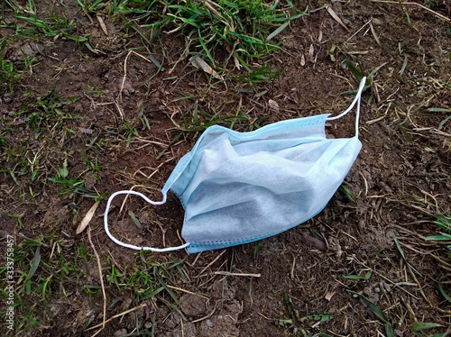 Coronavirus medical protective mask thrown to the ground