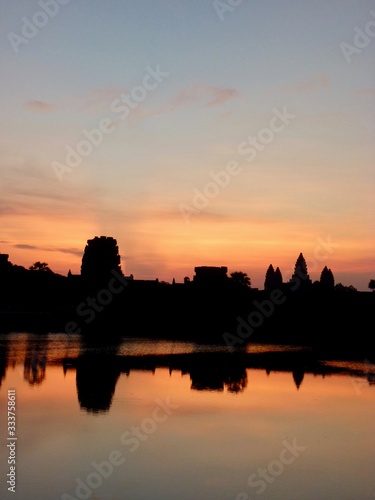 Angkor Wat during sunrise  shadows before lake with reflections  ruins of Angkor  Cambodia