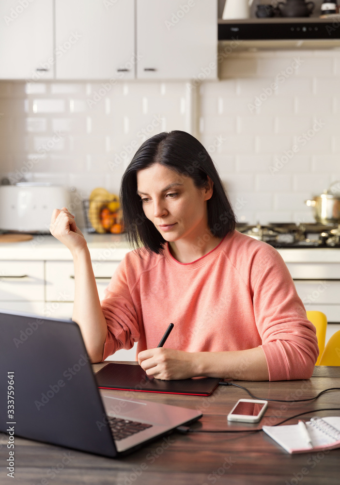 Woman works at home at the computer in quarantine Woman works at home at the computer in quarantine