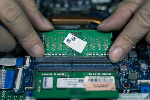 A close-up of an electrician repairing a computer circuit board,close up electrician hands are working with soldering iron