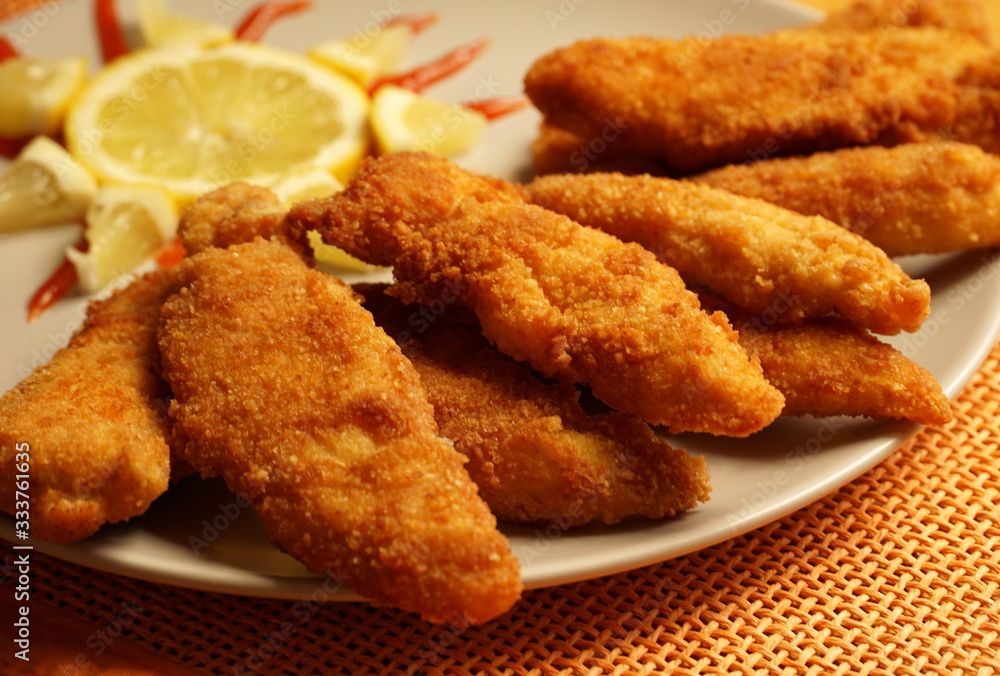 Fried chicken sticks, deep fried breaded chicken pieces close up Fried chicken sticks, deep fried breaded chicken pieces close up
