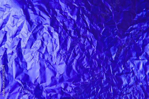 Background old crumpled foil paper blue color