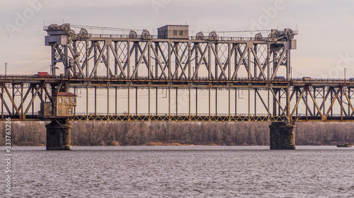 Old metal bridge across the Dnieper River in Eastern Europe, Ukraine photo