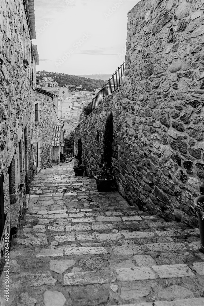 Obraz premium Tossa de Mar, Spain, August 2018. Black and white shot of a medieval street of the old city.
