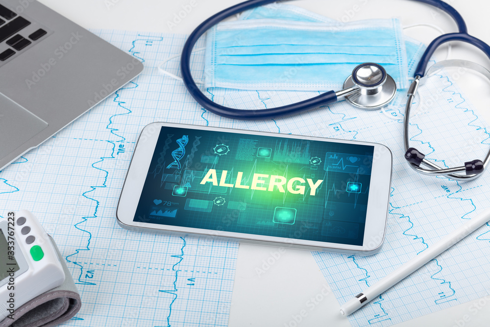 Tablet pc and medical stuff with ALLERGY inscription, prevention concept Tablet pc and medical stuff with ALLERGY inscription, prevention concept