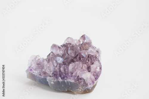 Large amethyst crystal close up photo. Natural stone isolated on light background.