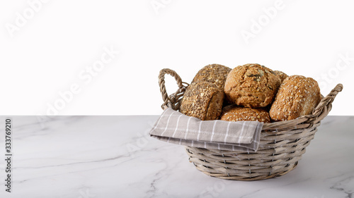 Fresh crispy bread rolls in the basket on a marble table