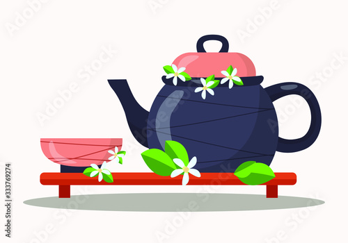 Chinese traditional tea ceremony: a ceramic Cup and teapot with Jasmine flowers and tea leaves stands on a low wooden stand