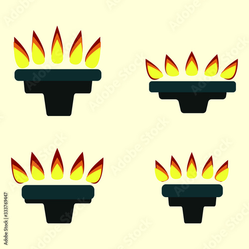 A set of gas burners of different sizes with a flame for cooking is isolated on a light yellow background. Olympic torch of the winner