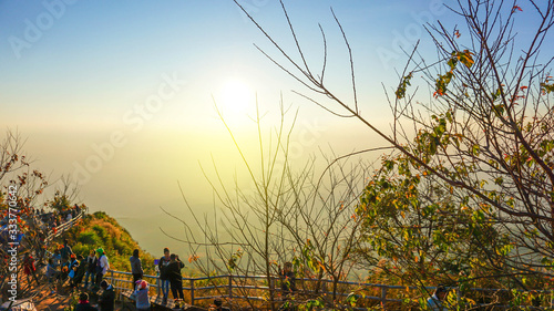 Golden light and yellow sky Of a beautiful evening sunset with the tree silhouette in Thailand
