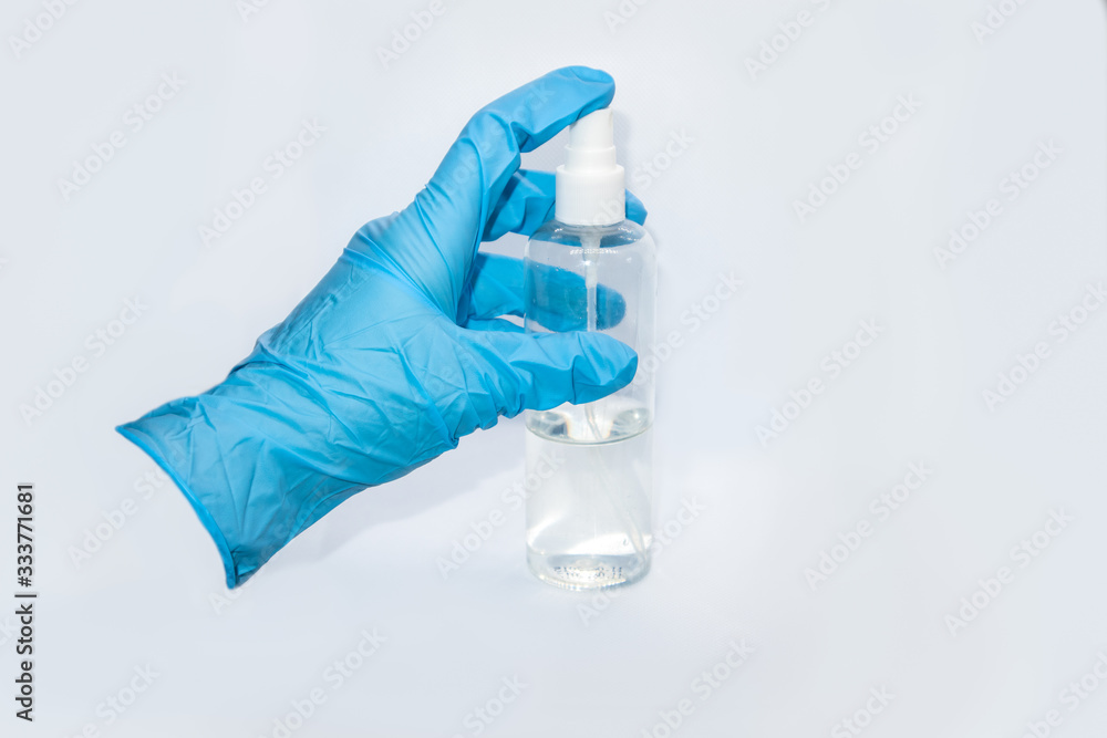 Spray disinfect liquid, hand in blue glove on white Spray disinfect liquid, hand in blue glove on white