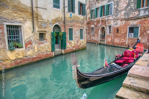 Gondola sailing through a canal in Venice.