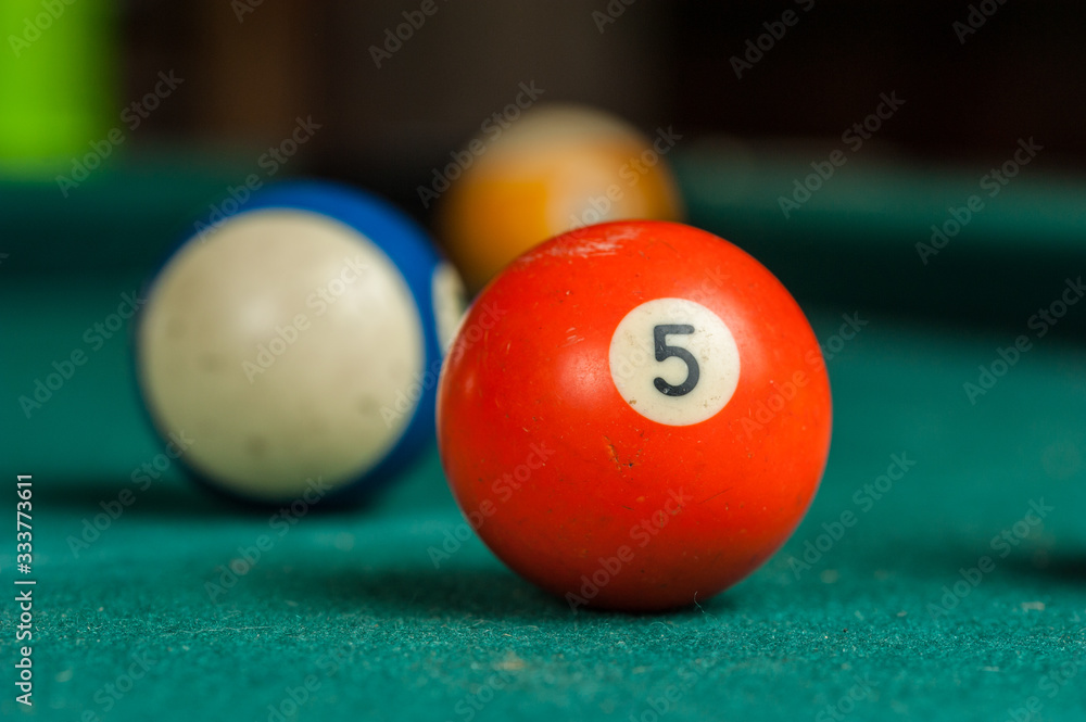 Billiards balls and cue on billiards table. Billiard sport concept Billiards balls and cue on billiards table. Billiard sport concept
