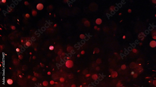 Luxury Glitter bokeh out of focus glittering particles sparks splash in camera on black background fashion photo for your special events projects.