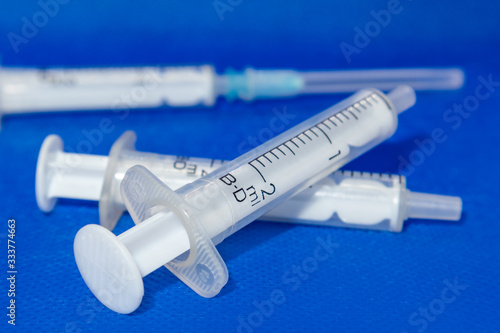 White 2 ml syringes macro on blue vibrant surface