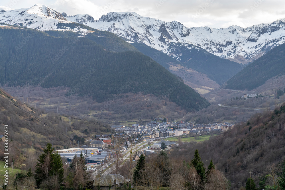 Views of Vielha with snowy mountains in the background.