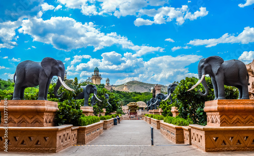 Entrance of The Palace / Lost City /Sun City with stone statues under blue and cloudy sky