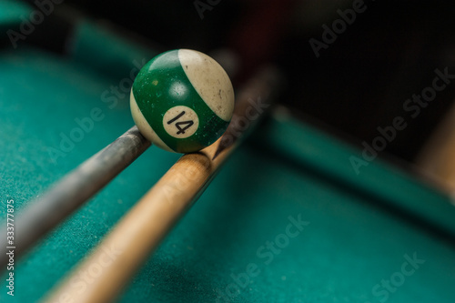 Billiards balls and cue on billiards table. Billiard sport concept