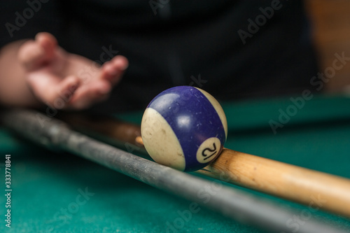 Billiards balls and cue on billiards table. Billiard sport concept